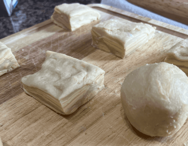 Separation of dough into three pieces, then twelve, and finally rolled into a ball